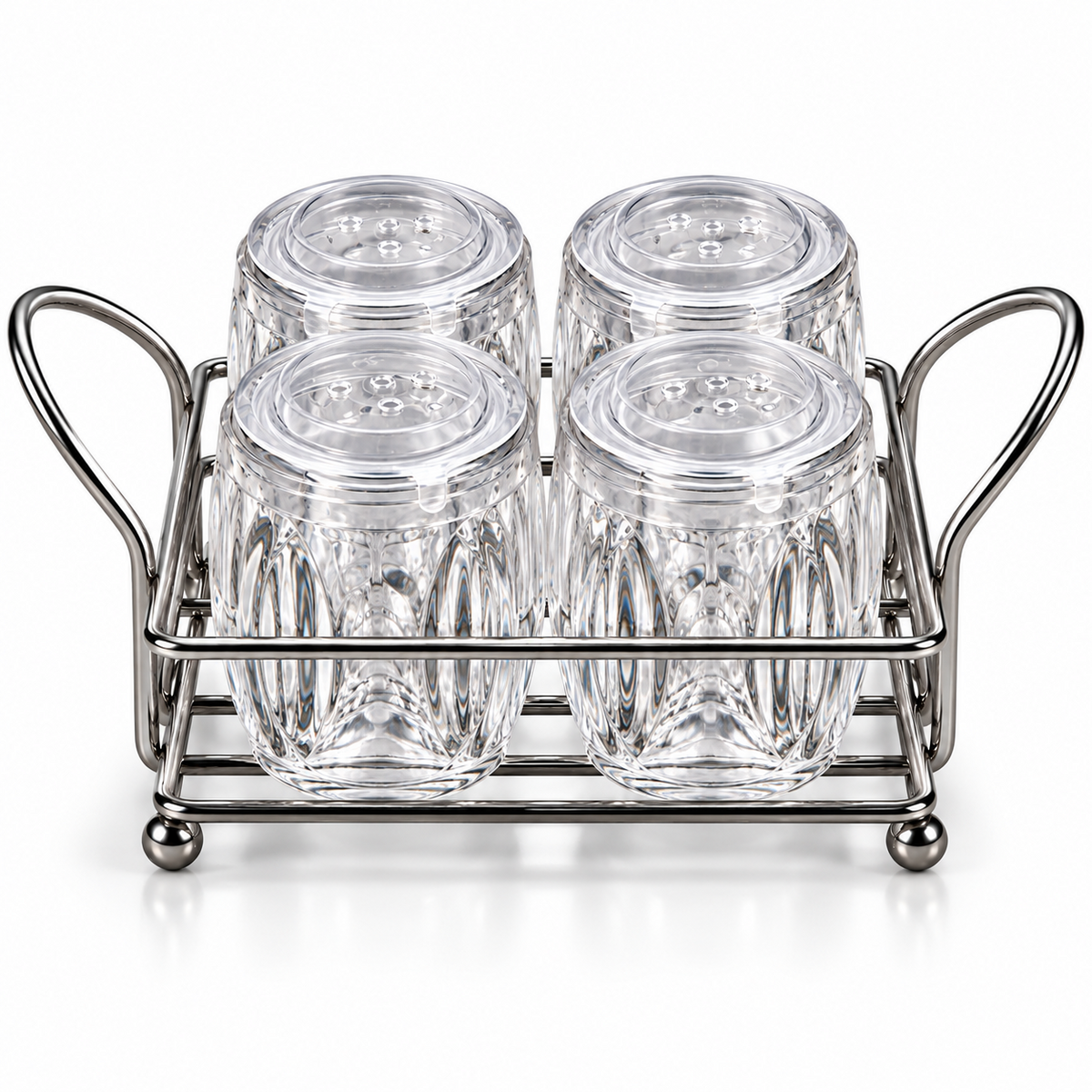 Four clear ribbed glass spice jars with perforated lids arranged in a silver-colour metal rack on white background